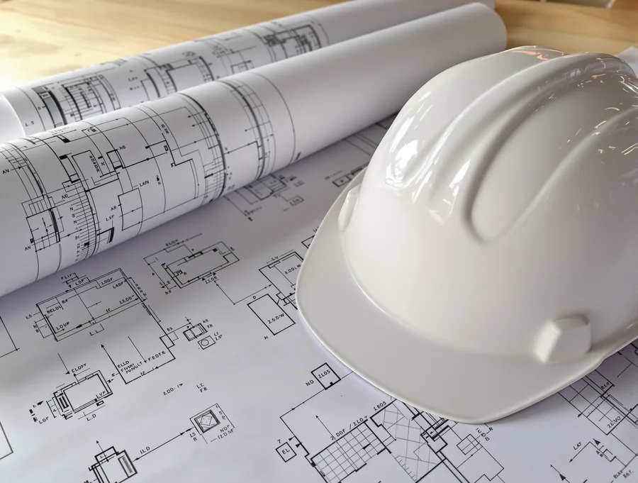 Architectural ADU blueprints on a table with drafting tools