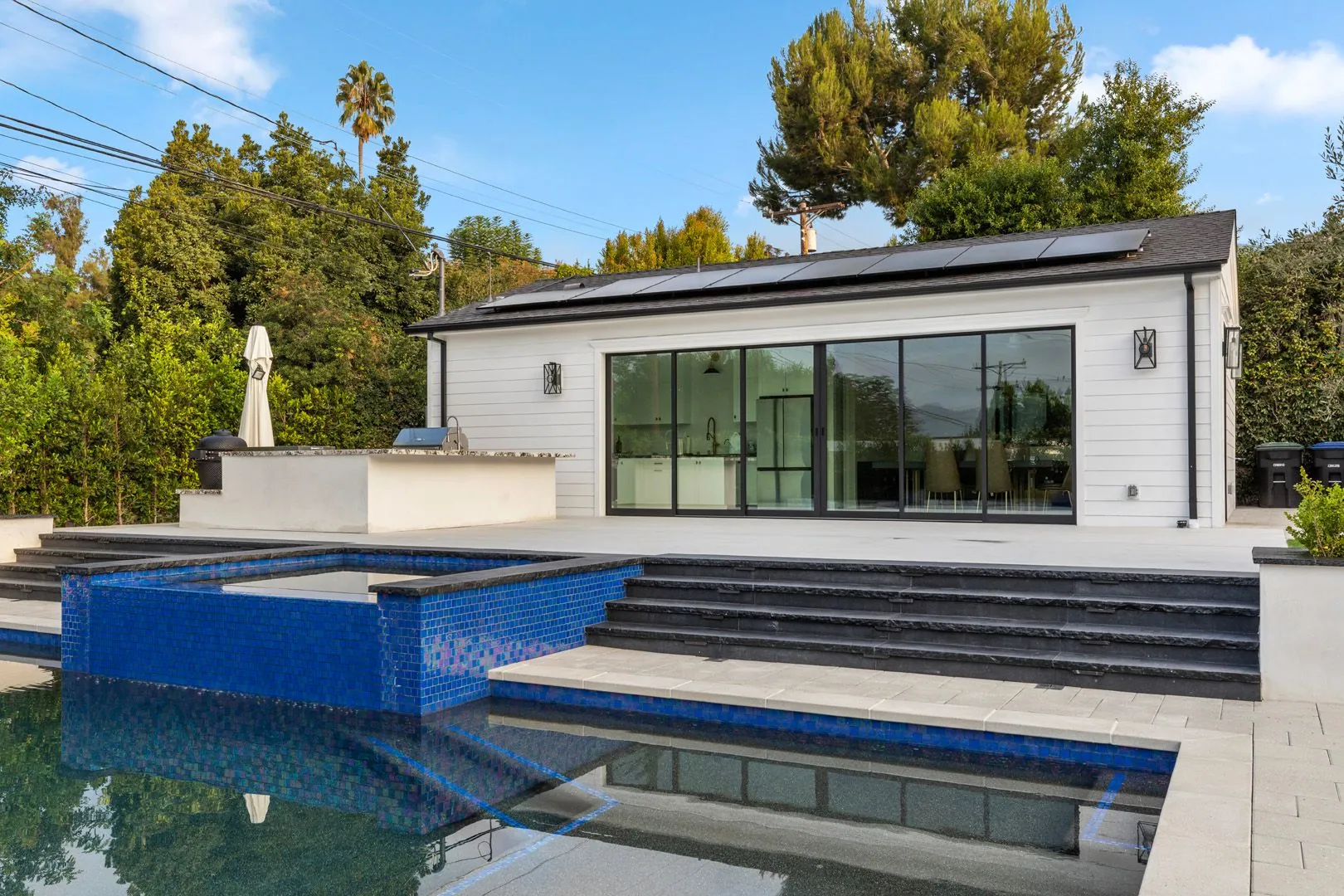 Modern detached ADU in Glendale with pool, blue mosaic spa and full-glass slider